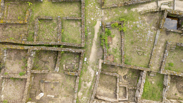 Aerial view of the ancient stone ruins of Castro de Armea featuring excavated foundations and green grass in Allariz Province of Ourense Spain. Aerial view of the ancient stone ruins of Castro de Armea featuring excavated foundations and green grass in Allariz Province of Ourense Spain.