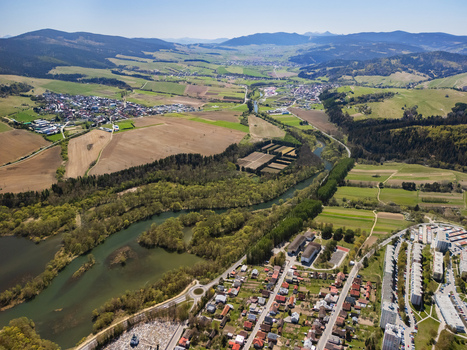 Aerial view of the town of Namestovo and the Orava river surrounded by lush green fields and rolling hills under a clear blue sky Namestovo Zilina Region Slovakia. Aerial view of the town of Namestovo and the Orava river surrounded by lush green fields and rolling hills under a clear blue sky Namestovo Zilina Region Slovakia.