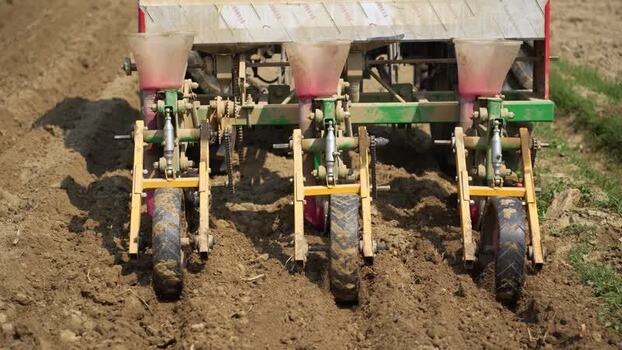 View of a mechanical seed drill planting in a field Nepal. View of a mechanical seed drill planting in a field Nepal.