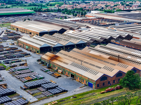 Aerial view of the vast industrial complex and steel pipe manufacturing facility with large warehouses and storage yards in Dalmine Lombardy Italy. Aerial view of the vast industrial complex and steel pipe manufacturing facility with large warehouses and storage yards in Dalmine Lombardy Italy.