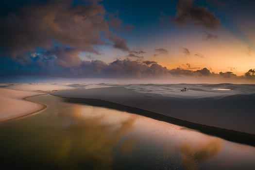 Aerial view of the vast white sand dunes and freshwater lagoons of Parque Nacional dos Lencois Maranhenses during a golden sunset Lencois Maranhenses MA Brazil. Aerial view of the vast white sand dunes and freshwater lagoons of Parque Nacional dos Lencois Maranhenses during a golden sunset Lencois Maranhenses MA Brazil.
