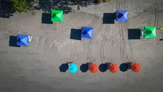 Aerial view of colorful beach umbrellas casting long shadows on the sandy shore a serene escape under the tropical sun Quepos Puntarenas Province Costa Rica. Aerial view of colorful beach umbrellas casting long shadows on the sandy shore a serene escape under the tropical sun Quepos Puntarenas Province Costa Rica.