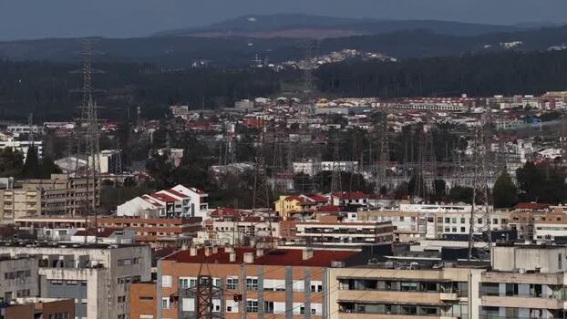 Aerial view of buildings electricity lines and pylons Portugal.