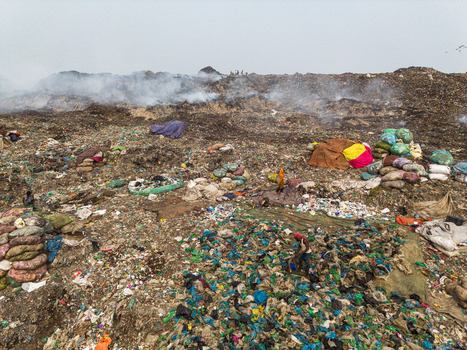 Aminbazar Bangladesh 26 January 2025 Aerial view of the Aminbazar landfill with smoke rising from piles of waste and people scavenging through garbage under a hazy sky. Aminbazar Bangladesh 26 January 2025 Aerial view of the Aminbazar landfill with smoke rising from piles of waste and people scavenging through garbage under a hazy sky.