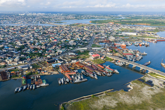 Port Harcourt Nigeria 03 July 2026 Aerial view of the bustling harbor and city landscape with numerous ships docked along the waterfront a bridge and urban development. Port Harcourt Nigeria 03 July 2026 Aerial view of the bustling harbor and city landscape with numerous ships docked along the waterfront a bridge and urban development.