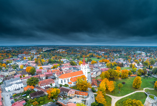 Aerial view of St. Johns Church surrounded by historic buildings and vibrant autumn foliage in the town of Cesis under a dramatic dark sky in Cesis Cesis Municipality Latvia. Aerial view of St. Johns Church surrounded by historic buildings and vibrant autumn foliage in the town of Cesis under a dramatic dark sky in Cesis Cesis Municipality Latvia.
