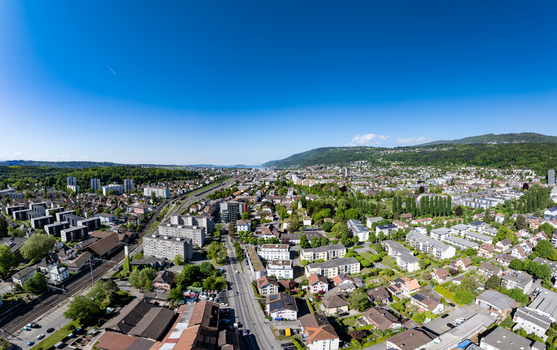 Aerial view of the urban landscape of Biel Bienne Boezingenfeld Champ featuring residential blocks industrial zones and railway tracks against forested hills Biel Bienne Canton of Bern Switzerland.