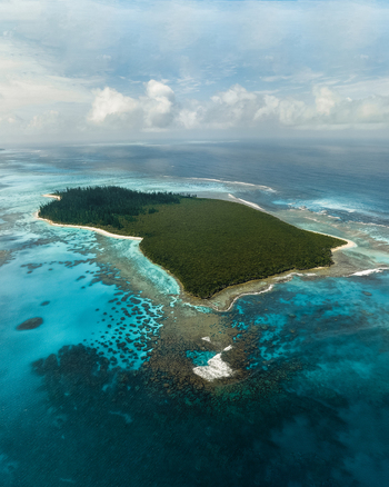 Aerial view of the contrasting turquoise waters and the lush green forest on the island creating a serene and vibrant landscape Pine Island New Caledonia. Aerial view of the contrasting turquoise waters and the lush green forest on the island creating a serene and vibrant landscape Pine Island New Caledonia.