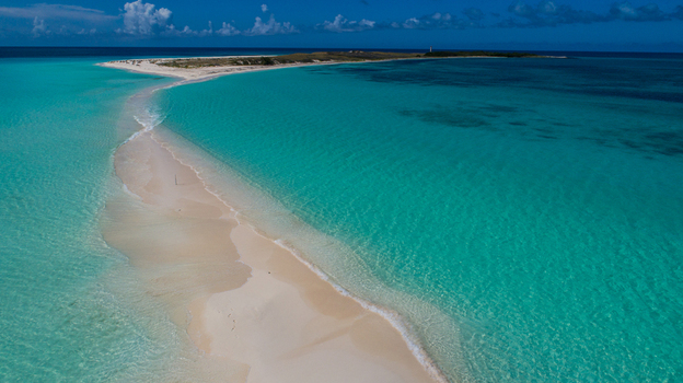Aerial view of Los Roques archipelago featuring a white sandbar surrounded by crystal clear turquoise waters in Los Roques Dependencias Federale Venezuela. Aerial view of Los Roques archipelago featuring a white sandbar surrounded by crystal clear turquoise waters in Los Roques Dependencias Federale Venezuela.