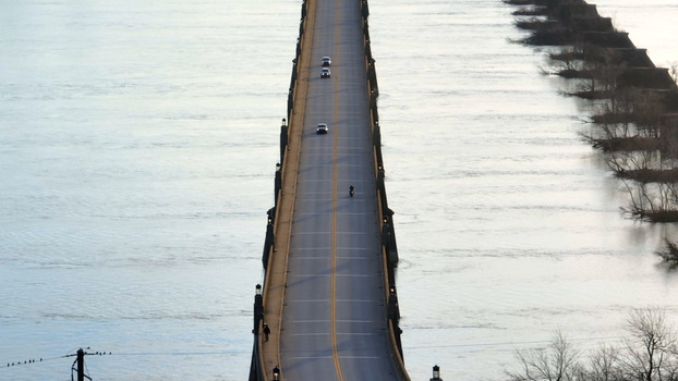 Aerial view of the Veterans Memorial Bridge spanning the Susquehanna River with cars driving across the road during sunset in Columbia Pennsylvania United States. Aerial view of the Veterans Memorial Bridge spanning the Susquehanna River with cars driving across the road during sunset in Columbia Pennsylvania United States.