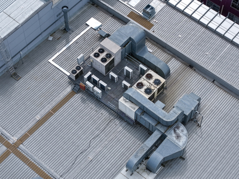 Melbourne VIC Australia 25 September 2026 Aerial view of industrial HVAC units ventilation ducts and cooling fans installed on a corrugated metal rooftop.