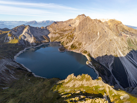 Aerial view of Lunersee a high altitude alpine lake surrounded by rugged mountain peaks and rocky slopes in Vandans Vorarlberg Austria. Aerial view of Lunersee a high altitude alpine lake surrounded by rugged mountain peaks and rocky slopes in Vandans Vorarlberg Austria.