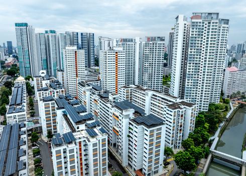Aerial view of high rise HDB residential apartment blocks with solar panels on rooftops along the Whampoa River in Singapore Singapore. Aerial view of high rise HDB residential apartment blocks with solar panels on rooftops along the Whampoa River in Singapore Singapore.