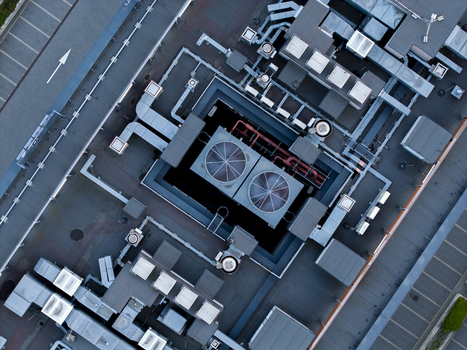 Aerial view of the industrial rooftop of a data center featuring complex HVAC ventilation systems metallic ducts and cooling units in Krakow Lesser Poland Voivode Poland. Aerial view of the industrial rooftop of a data center featuring complex HVAC ventilation systems metallic ducts and cooling units in Krakow Lesser Poland Voivode Poland.