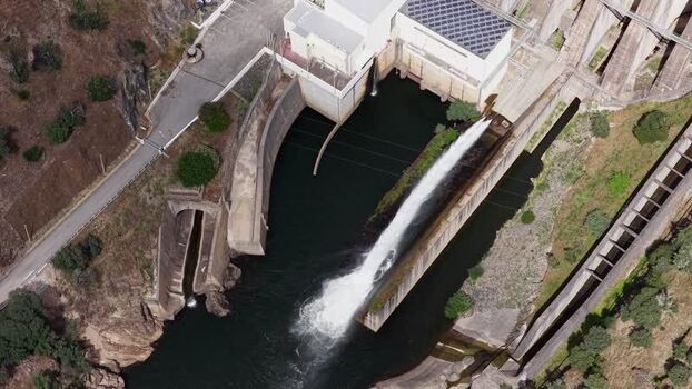 Aerial view of Barragem da Pracana with water discharge Portugal.