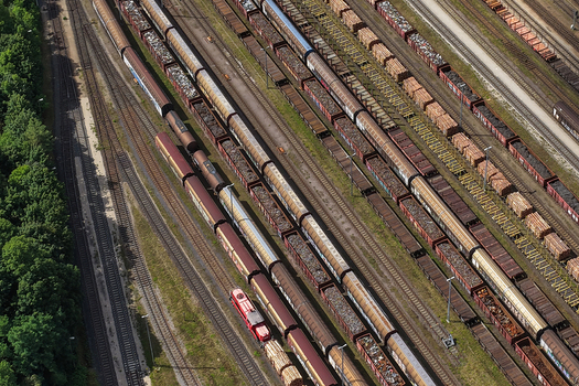 Aerial view of freight trains parked on multiple parallel tracks in a railway yard in Saalfeld Thuringia Germany. Aerial view of freight trains parked on multiple parallel tracks in a railway yard in Saalfeld Thuringia Germany.