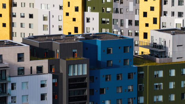 Aerial view of a modern apartment complex with colorful facades flat roofs and balconies in Iceland. Aerial view of a modern apartment complex with colorful facades flat roofs and balconies in Iceland.