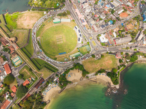 Aerial view of Galle International Stadium and the historic fort walls next to the turquoise ocean and busy coastal roads in Galle Southern Province Sri Lanka. Aerial view of Galle International Stadium and the historic fort walls next to the turquoise ocean and busy coastal roads in Galle Southern Province Sri Lanka.