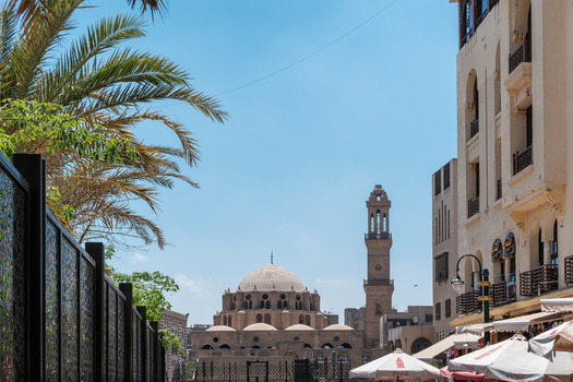 El Darb El Ahmar Egypt 20 April 2026 View of Abu Dahab Mosque with its stone dome and minaret under a clear blue sky framed by palm trees and urban buildings. El Darb El Ahmar Egypt 20 April 2026 View of Abu Dahab Mosque with its stone dome and minaret under a clear blue sky framed by palm trees and urban buildings.