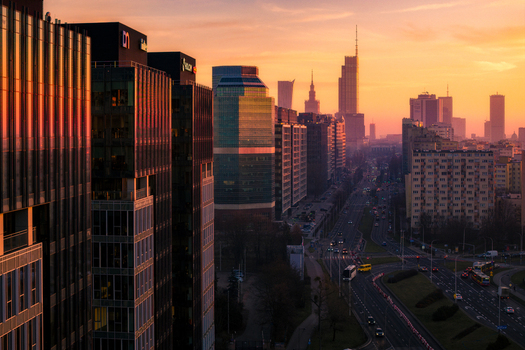 Warsaw Poland 18 January 2025 Aerial view of modern skyscrapers and office buildings at sunset with a busy road and urban traffic below in the city center. Warsaw Poland 18 January 2025 Aerial view of modern skyscrapers and office buildings at sunset with a busy road and urban traffic below in the city center.