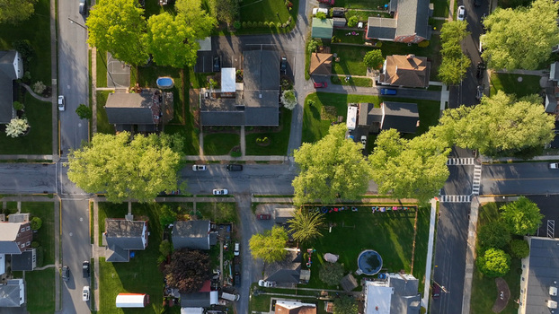 Aerial view of a quiet residential neighborhood with suburban houses green lawns mature trees and paved streets in Denver Pennsylvania United States.
