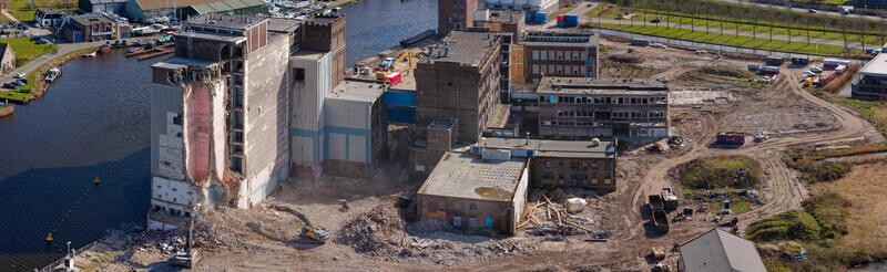 Aerial view of the skeletal remains of the Meneba Flour Mill stand against the skyline during its demolition Wormerveer Netherlands. Aerial view of the skeletal remains of the Meneba Flour Mill stand against the skyline during its demolition Wormerveer Netherlands.