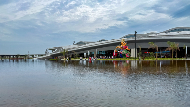 Bhogapuram India 22 August 2026 View of Alluri Sitarama Raju International Airport terminal building with a reflective water feature and decorative sculptures under a cloudy sky. Bhogapuram India 22 August 2026 View of Alluri Sitarama Raju International Airport terminal building with a reflective water feature and decorative sculptures under a cloudy sky.