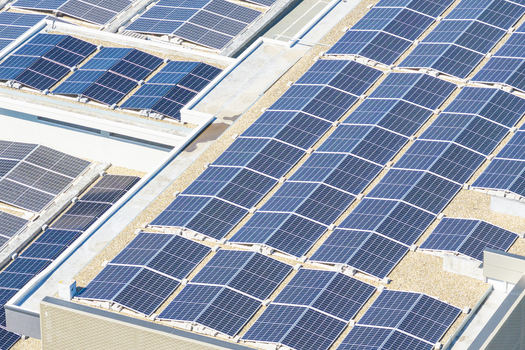Aerial view of solar panels installed on a flat commercial rooftop in Arezzo Tuscany Italy. Aerial view of solar panels installed on a flat commercial rooftop in Arezzo Tuscany Italy.