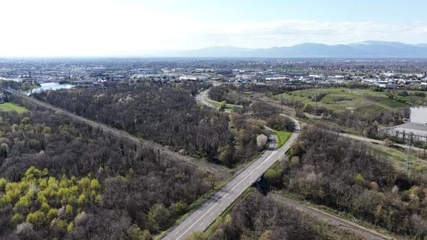 Aerial view of road cutting through forest France.