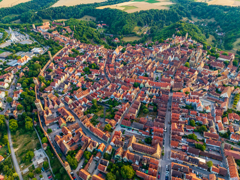 Aerial view of the historic medieval town with iconic red tiled rooftops ancient city walls and lush greenery in Rothenburg ob der Tauber Bavaria Germany. Aerial view of the historic medieval town with iconic red tiled rooftops ancient city walls and lush greenery in Rothenburg ob der Tauber Bavaria Germany.