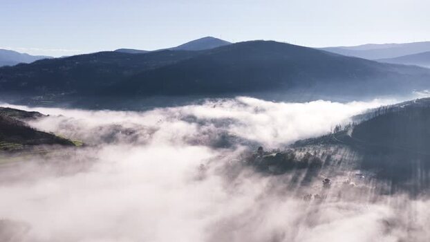 Aerial view of Avo village covered in thick fog and mountains Portugal. Aerial view of Avo village covered in thick fog and mountains Portugal.