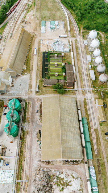 Aerial view of an industrial complex featuring large warehouses spherical storage tanks and railway tracks with freight cars Sabac Vojvodina Serbia. Aerial view of an industrial complex featuring large warehouses spherical storage tanks and railway tracks with freight cars Sabac Vojvodina Serbia.