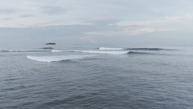 Aerial view of ocean waves breaking near Siargao Philippines.