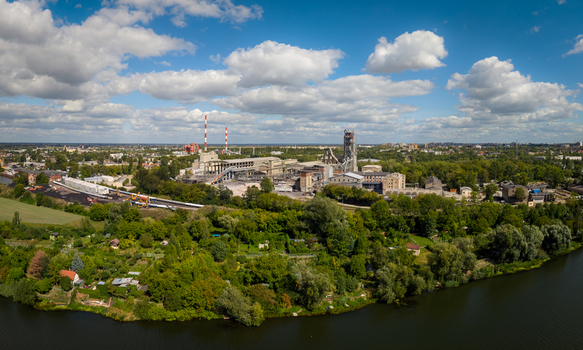 Opole Poland 06 September 2026 Aerial view of the Cement Odra SA industrial plant situated along the Oder river surrounded by lush green trees and urban landscape under a blue sky with white clouds. Opole Poland 06 September 2026 Aerial view of the Cement Odra SA industrial plant situated along the Oder river surrounded by lush green trees and urban landscape under a blue sky with white clouds.