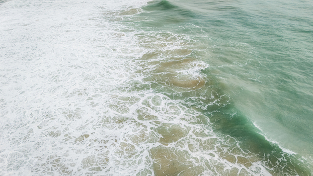 Aerial view of turquoise ocean waves crashing with white foam and surf Sagres Faro Portugal. Aerial view of turquoise ocean waves crashing with white foam and surf Sagres Faro Portugal.
