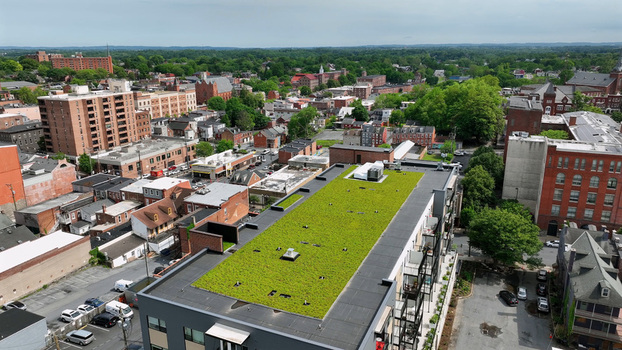 Aerial view of a modern building with a green roof in South Lancaster featuring surrounding historic brick buildings streets and trees in Lancaster Pennsylvania United States. Aerial view of a modern building with a green roof in South Lancaster featuring surrounding historic brick buildings streets and trees in Lancaster Pennsylvania United States.