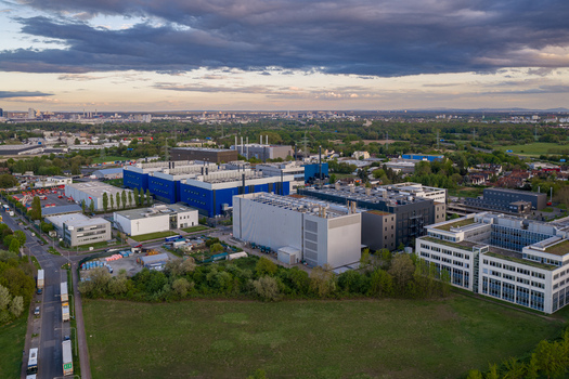 Aerial view of the Digital Realty Frankfurt FRA30 data center complex with modern industrial buildings and greenery under a cloudy sky Frankfurt am Main Hessen Germany. Aerial view of the Digital Realty Frankfurt FRA30 data center complex with modern industrial buildings and greenery under a cloudy sky Frankfurt am Main Hessen Germany.