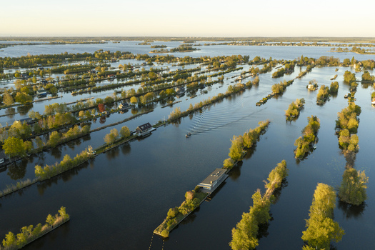 Aerial view of Scheendijk in the Loosdrechtse Plassen featuring narrow strips of land with houses and trees surrounded by calm water Breukelen Utrecht Netherlands. Aerial view of Scheendijk in the Loosdrechtse Plassen featuring narrow strips of land with houses and trees surrounded by calm water Breukelen Utrecht Netherlands.