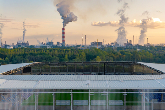 Plock Mazowieckie Voivodeship Poland 10 September 2026 Aerial view of the ORLEN S.A. oil refinery with smoking chimneys behind a modern stadium with a green pitch. Plock Mazowieckie Voivodeship Poland 10 September 2026 Aerial view of the ORLEN S.A. oil refinery with smoking chimneys behind a modern stadium with a green pitch.