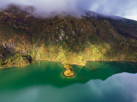 Aerial view of Lagoa do Fogo with its turquoise waters and steep green volcanic slopes partially covered by mist Agua de Alto Azores Portugal. Aerial view of Lagoa do Fogo with its turquoise waters and steep green volcanic slopes partially covered by mist Agua de Alto Azores Portugal.