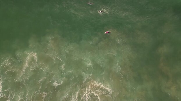 Aerial view of surfers in the ocean at Praia da Mata Portugal. Aerial view of surfers in the ocean at Praia da Mata Portugal.