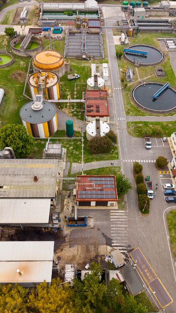 Aerial view of the Depuratore di San Giuliano Milanese Ovest wastewater treatment plant with circular sedimentation tanks industrial buildings and access roads in Rancate Lombardia Italy. Aerial view of the Depuratore di San Giuliano Milanese Ovest wastewater treatment plant with circular sedimentation tanks industrial buildings and access roads in Rancate Lombardia Italy.