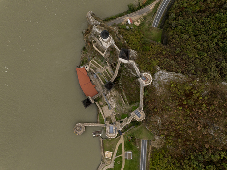 Aerial view of the historic Golubac Fortress situated on the banks of the Danube River featuring stone walls towers and surrounding lush greenery in Golubac Branicevski okrug Serbia. Aerial view of the historic Golubac Fortress situated on the banks of the Danube River featuring stone walls towers and surrounding lush greenery in Golubac Branicevski okrug Serbia.