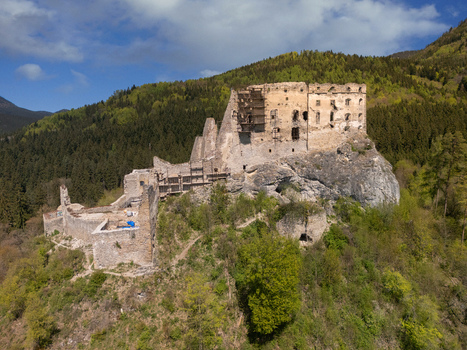 Aerial view of Castle Likava on a rocky hill surrounded by lush green forests and mountains in Likavka Zilina Region Slovakia. Aerial view of Castle Likava on a rocky hill surrounded by lush green forests and mountains in Likavka Zilina Region Slovakia.