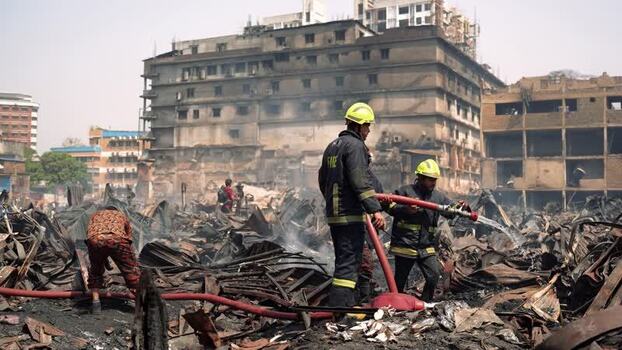View of firefighters working at a fire scene in Dhaka Bangladesh. View of firefighters working at a fire scene in Dhaka Bangladesh.
