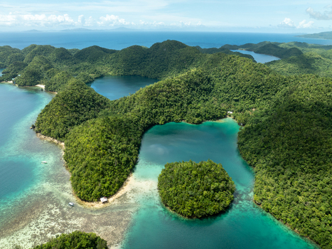 Aerial view of Bucas Grande featuring lush green islands surrounded by turquoise lagoons and coral reefs in Siargao Philippines. Aerial view of Bucas Grande featuring lush green islands surrounded by turquoise lagoons and coral reefs in Siargao Philippines.