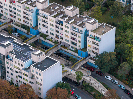 Aerial view of the High Deck Siedlung residential complex featuring elevated pedestrian walkways modern apartment buildings and surrounding greenery in Berlin Berlin Germany. Aerial view of the High Deck Siedlung residential complex featuring elevated pedestrian walkways modern apartment buildings and surrounding greenery in Berlin Berlin Germany.
