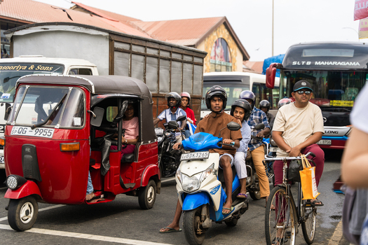 Sri Lanka 07 January 2026 View of busy street traffic featuring colorful tuk tuks motorcycles and a public bus on a crowded urban road.