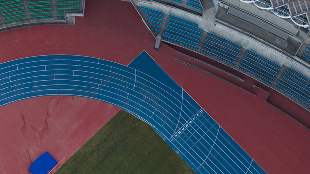 Aerial view of the blue running track and colorful seating at Kaohsiung National Stadium in Juguang Village Kaohsiung City Taiwan.