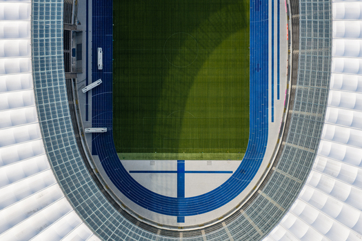 Berlin Germany 26 September 2026 Aerial view of Olympiastadion Berlin showing the green pitch and blue running track from a high angle.